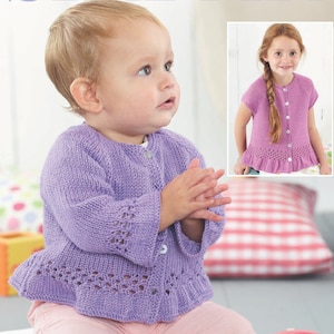 May include: A purple knitted cardigan with a ruffled hem and button closure. The cardigan has a delicate lace pattern on the sleeves and hem.