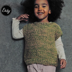 May include: A child wearing a green and tan knitted vest over a long-sleeved white shirt. The vest has a textured pattern. The word "Easy" is in a black circle in the upper left corner.