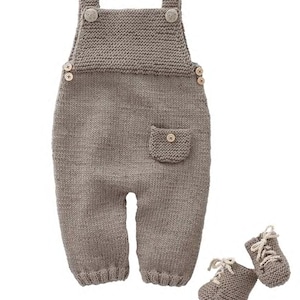 May include: A knitted brown baby romper with a pocket and matching knitted booties. The romper has buttons on the shoulders and the booties have laces.