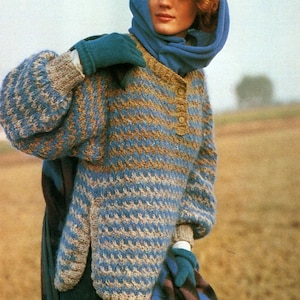 May include: A blue and brown striped knitted jumper with a button fastening at the neck. The jumper has a relaxed fit and is worn with a blue scarf and teal gloves.