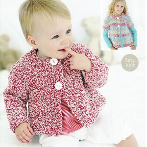 May include: A pink and white knitted cardigan with white buttons. The cardigan is shown on a baby.