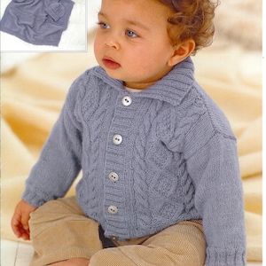 May include: A light blue knitted baby cardigan with a collar and three buttons. The cardigan has a cable knit design and is paired with tan corduroy pants. A matching knitted blanket and hat are in the upper left corner.