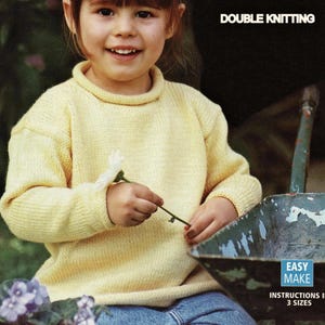 May include: A young person wearing a yellow knitted jumper with a turtleneck collar. The jumper is made using a double knitting technique. The text "DOUBLE KNITTING" is visible at the top of the image. The text "EASY MAKE" and "INSTRUCTIONS IN 3 SIZES" is visible at the bottom of the image.