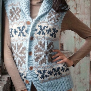 May include: A light blue knitted vest with a shawl collar and wooden buttons. The vest features a geometric pattern in shades of brown, white, and navy blue. The vest is a cozy, warm garment.