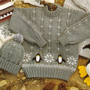 May include: A gray knitted sweater with a cable knit pattern and penguin and snowflake design. The sweater is paired with a gray knitted hat with a pom-pom.
