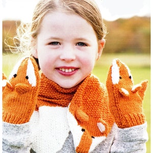 May include: A child wearing a knitted fox scarf and matching mittens. The scarf and mittens are orange and white with fox faces.