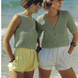 Puede incluir: Dos mujeres con tops de punto verde claro y pantalones cortos en la playa. Una lleva un top sin mangas con pantalones cortos amarillos, la otra una rebeca con pantalones cortos blancos. Ambas tienen pulseras.