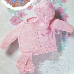 May include: A pink knitted baby cardigan, hat and booties set. The cardigan has a button fastening and a delicate stitch pattern. The hat has a matching stitch pattern and a bow. The booties have a bow detail.