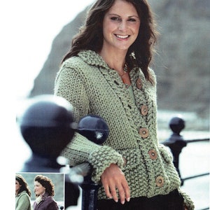 May include: A green knitted cardigan with a hood, pockets, and button closure. The cardigan is being worn by a person with long brown hair.