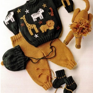 May include: A knitted baby outfit set in green and brown with a matching hat and booties. The set features a sweater with a giraffe, zebra, and lion design. A separate lion stuffed toy is also included.