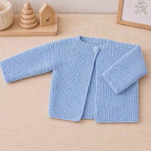 May include: A light blue long-sleeved knit cardigan featuring a garter stitch texture and a single small white button closure at the neckline. The garment is constructed with a simple open front design and long sleeves, showcasing a uniform knit pattern.