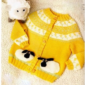 May include: A yellow knitted cardigan with a white and yellow patterned design. The cardigan has a button closure and features two white sheep appliques on the front.
