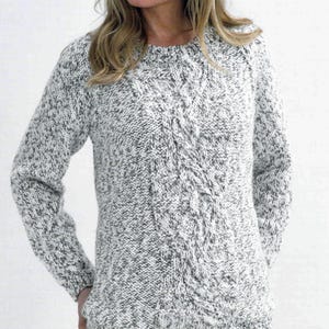 May include: A white and gray cable knit sweater with a round neckline and long sleeves.