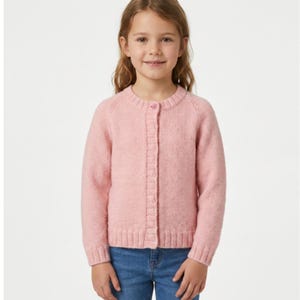 May include: A soft, light pink knit cardigan featuring a round neckline, long sleeves, and a vertical button-down front closure with a ribbed texture along the placket, cuffs, and hem, paired with classic blue denim jeans.