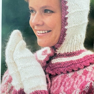 May include: A knitted winter ensemble in white and pink. The set includes a hooded scarf, mittens, and a sweater. The hood and mittens are white with pink trim. The sweater features a pink and white patterned design. The ensemble is made of a soft, textured yarn.