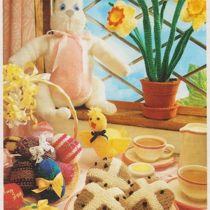 May include: A collection of knitted Easter crafts including a bunny, chick, daffodils, hot cross buns, and Easter eggs.