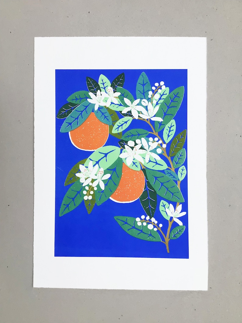 May include: A print of an orange tree with white blossoms and two orange fruits on a bright blue background.