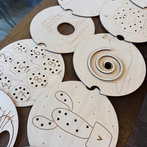 May include: A set of three ceramic mugs with a speckled, matte finish. The mugs are in cream, light grey, and dark grey. Each mug has a simple, minimalist design, ideal for coffee or tea.