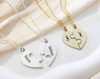 May include: Two silver necklaces with heart-shaped puzzle pieces that say "Kevin" and "Selena" on them. A gold necklace with heart-shaped puzzle pieces that say "K.S" and "S.K" on them.