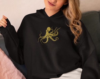 May include: A black hoodie with a gold octopus graphic on the front. The hoodie has a drawstring hood and a kangaroo pocket.