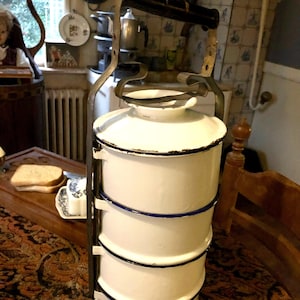 Vintage 1950s set of enamel food carriers, stack of pans, rantang.