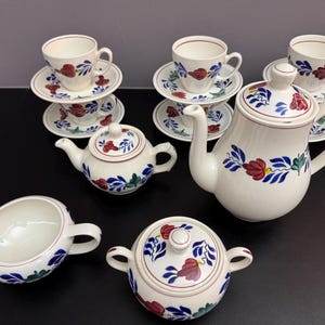 16-piece farmhouse-style coffee and tea set; teapot, coffee pot, sugar bowl, milk jug, and 6 cups and saucers.