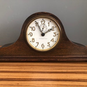 Vintage intermittent butterfly alarm clock in the shape of a small mantel clock, shelf clock.