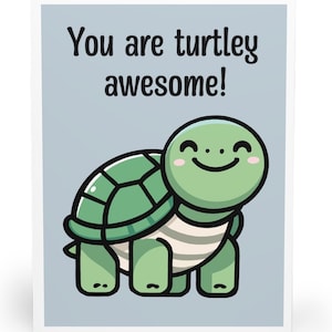May include: A folded greeting card with a light blue background featuring a cartoon turtle with a green shell and a light-coloured underbelly. The turtle has a smiling face with pink cheeks. The text reads: You are turtley awesome!