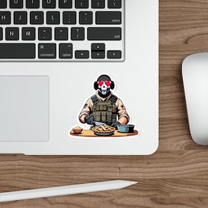 May include: A cartoon illustration of a person wearing a military uniform and a skull mask with hearts for eyes. The person is holding a knife and is standing in front of a table with a pie on it.