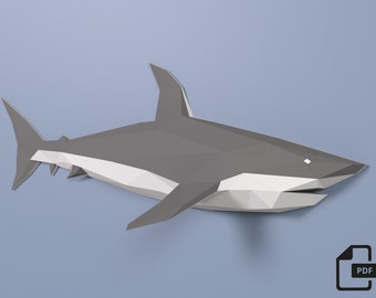 May include: A gray and white origami paper model of a shark. The shark is in a swimming position with its mouth open. The model is made of folded paper and has a realistic appearance.