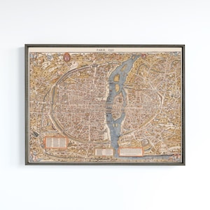 May include: Framed vintage map of Paris from 1550, featuring a detailed bird's-eye view of the city. The map is in shades of brown, beige, and blue, with the text "PARIS 1550" at the top. The map is enclosed in a dark gray frame.