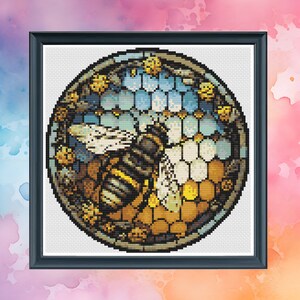 May include: A circular cross-stitch pattern featuring a bee surrounded by honeycomb and flowers. The bee is brown and yellow with black stripes. The honeycomb is yellow and brown. The flowers are blue, yellow, and white.