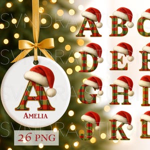 May include: A white Christmas ornament with a gold ribbon and bow, featuring the letter "A" in a red and green plaid pattern, topped with a Santa hat. The name "Amelia" is printed below the letter. Additional letters A-L are shown with Santa hats.
