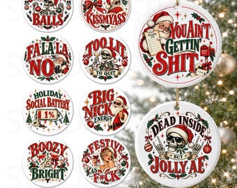 May include: A collection of round white Christmas ornaments featuring various holiday-themed illustrations and text, including skeletons, Santa Claus, and humorous phrases like Check Out My Balls, You Ain't Gettin' Shit, and Dead Inside But Jolly AF.