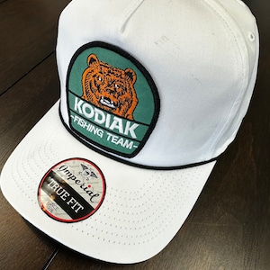 Lions, Tigers and Kodiak Bears! A very nice pairing of the vintage Kodiak Bear Fishing Team patch and a bright white Imperial True Fit Cap
