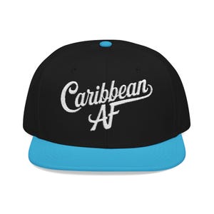 May include: Black and blue flat-brimmed baseball cap with the embroidered text "Caribbean AF" in white script. The cap features a blue brim and a blue button on top, offering a bold, two-tone design.