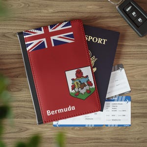 May include: A red passport holder with the flag of Bermuda and the word "Bermuda" printed on it. The holder is lying on top of a blue passport and two airline boarding passes.