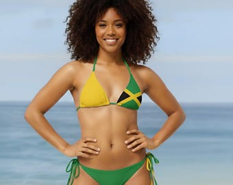 May include: A two-piece bikini featuring a triangle top and side-tie bottoms. The top has one solid yellow cup and one cup displaying the Jamaican flag pattern. The bottoms are solid green with yellow and green side ties for adjustment.