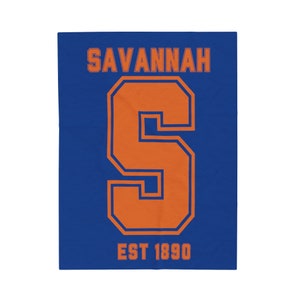 Puede incluir: Un diseño gráfico azul y naranja con el texto "SAVANNAH" y una gran "S" naranja con contorno azul. El texto "EST 1890" está debajo de la "S".