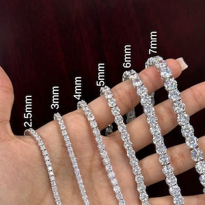 May include: A set of seven silver tennis bracelets with different sized round stones. The bracelets are arranged in order of size, from smallest to largest, with the smallest bracelet being 2.5mm and the largest bracelet being 7mm.