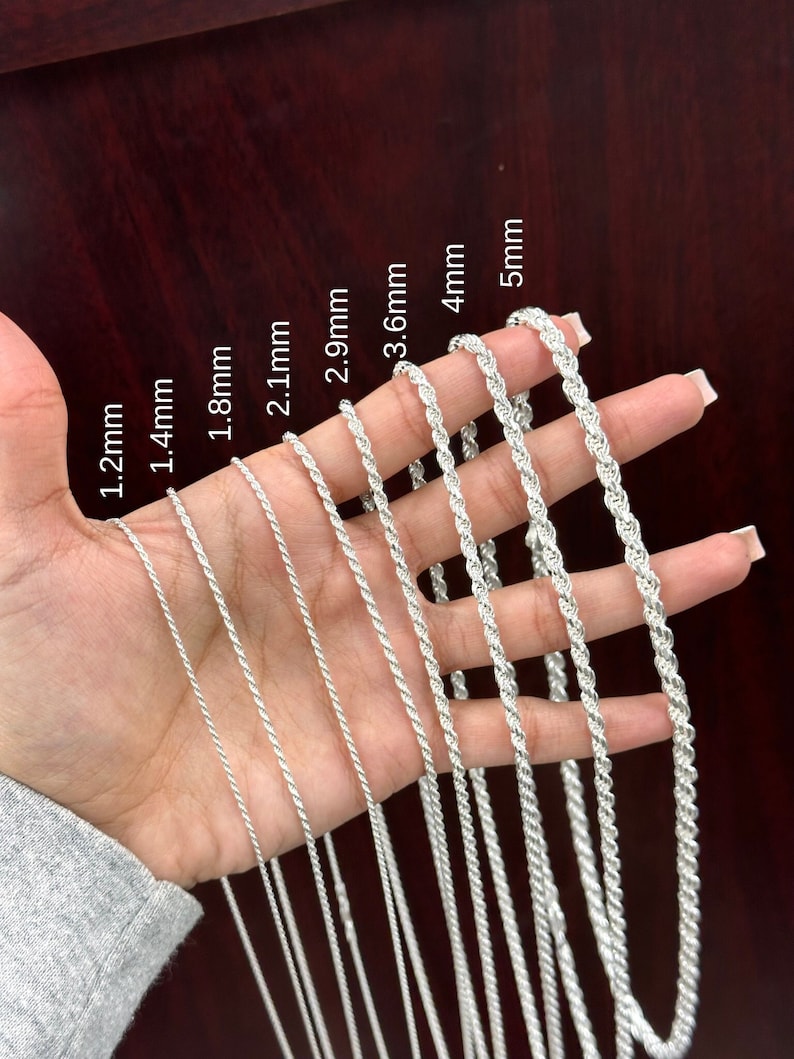 May include: A close-up of a hand holding a variety of silver rope chains. The chains are labeled with their thickness in millimeters: 1.2mm, 1.4mm, 1.8mm, 2.1mm, 2.9mm, 3.6mm, 4mm, and 5mm.