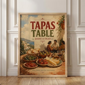 May include: A framed vintage poster with the words "TAPAS TABLE" in red and green. The image shows a table of tapas, with people dining in the background. The poster includes the text "SHARE & ENJOY" and "Color, flavor, and slow conversation."