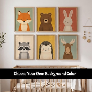 May include: Six framed wall art prints featuring illustrations of a fox, bear, rabbit, raccoon, hedgehog, and moose, displayed above a wooden crib. The text "Choose Your Own Background Color" is overlaid across the center of the image.