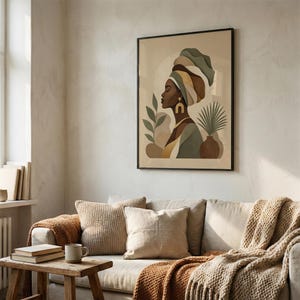 May include: A framed art print featuring a profile of a woman wearing a colorful head wrap and gold earrings. The artwork has a neutral color palette with green, brown, and yellow accents. A vase with a plant is also depicted.