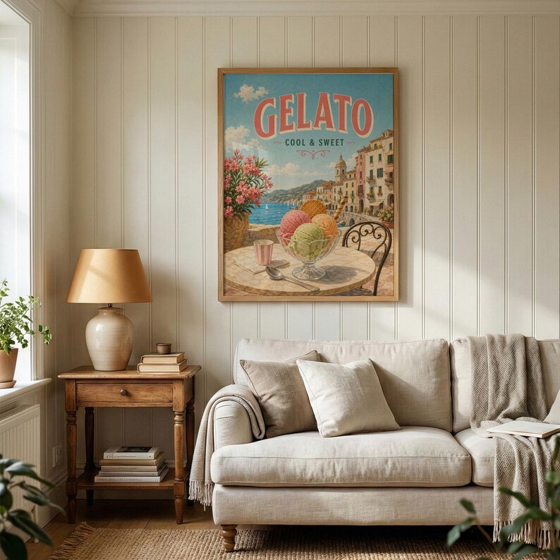 May include: A framed vintage-style poster with the word "Gelato" in pink lettering. The poster depicts a seaside scene with colorful buildings, a table with ice cream, and the text "Cool & Sweet."