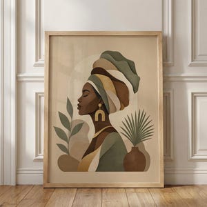 May include: A framed art print featuring a profile of a woman wearing a turban in shades of green, brown, and gold. The artwork includes botanical elements and a neutral background, creating a serene and elegant aesthetic.
