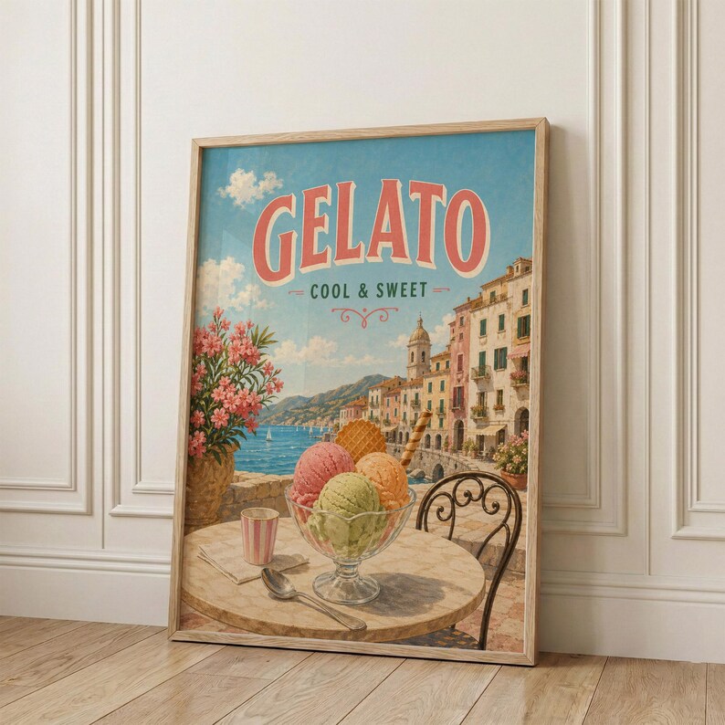 May include: A framed vintage-style poster with the word "Gelato" in large red letters. The poster depicts a seaside scene with colorful buildings, a table with gelato, and a cup. The words "Cool & Sweet" are below the word "Gelato".