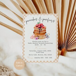 May include: Baby shower invitation with the text "pancakes & pacifiers." The invitation features a stack of pancakes topped with berries and syrup, along with pacifier illustrations. The invitation includes the date, time, location, and RSVP information.