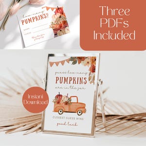 May include: Printable game sign with a watercolor floral design and a truck carrying pumpkins. The sign says "guess how many pumpkins are in the jar" and "closest guess wins good luck".