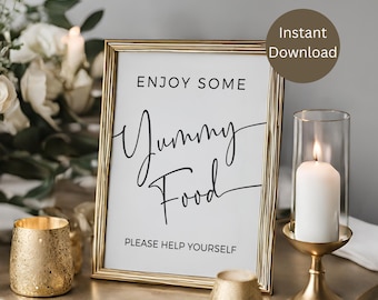 May include: A gold-framed sign with the text "Enjoy Some Yummy Food" and "Please Help Yourself" in black calligraphy. The sign is on a table with gold candlesticks and white candles.